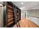 Library featuring floor-to-ceiling dark wood bookshelves with a rolling ladder at 3201 Hobsons Ridge Nw Trl, Acworth, GA 30101