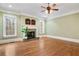 Spacious living room featuring a stone fireplace, hardwood floors, and abundant natural light at 3201 Hobsons Ridge Nw Trl, Acworth, GA 30101