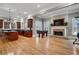 Open-concept layout with a modern kitchen, fireplace, and adjacent rec space for seamless living at 3201 Hobsons Ridge Nw Trl, Acworth, GA 30101