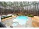 Aerial shot of a pool, hot tub, and basketball court surrounded by lush landscaping and mature trees at 3201 Hobsons Ridge Nw Trl, Acworth, GA 30101
