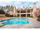 Stunning backyard pool with a diving board, spacious patio, and view of the home's outdoor living space at 3201 Hobsons Ridge Nw Trl, Acworth, GA 30101