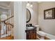 Stylish half-bathroom featuring a decorative vanity with marble countertop and modern fixtures at 3201 Hobsons Ridge Nw Trl, Acworth, GA 30101