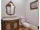 Chic powder room featuring a decorative mirror, marble countertop, and elegant fixtures at 3201 Hobsons Ridge Nw Trl, Acworth, GA 30101