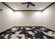 Interesting room with custom cow print rug, neutral walls with black trim, and a ceiling fan at 3201 Hobsons Ridge Nw Trl, Acworth, GA 30101