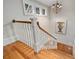 Staircase with decorative newel post, hardwood floors, and a modern chandelier at 3201 Hobsons Ridge Nw Trl, Acworth, GA 30101