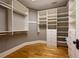 Spacious walk-in closet with custom shelving and wooden floors providing ample storage solutions at 3201 Hobsons Ridge Nw Trl, Acworth, GA 30101