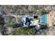An aerial shot showcases the home, in-ground pool, tennis court, and surrounding wooded property at 4000 Conway Valley Nw Rd, Atlanta, GA 30327