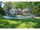 Beautiful backyard with pool, lush lawn, and meticulously landscaped grounds at 4000 Conway Valley Nw Rd, Atlanta, GA 30327