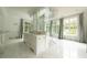 Bright bathroom featuring a double vanity, marble floors, and a separate tub and shower at 4000 Conway Valley Nw Rd, Atlanta, GA 30327