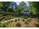A charming two-story home boasts lush landscaping and a stone walkway at 4000 Conway Valley Nw Rd, Atlanta, GA 30327