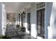 Inviting front porch with black painted wood floor, white columns, and lantern sconces at 4000 Conway Valley Nw Rd, Atlanta, GA 30327