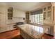 Well-lit kitchen with granite counters, stainless appliances, central island, and classic cabinetry at 4000 Conway Valley Nw Rd, Atlanta, GA 30327