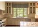 Bright kitchen with white cabinetry, granite countertops, and a large window overlooking the backyard at 4000 Conway Valley Nw Rd, Atlanta, GA 30327