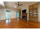 Cozy living room with fireplace, hardwood floors, and built-in shelving at 4000 Conway Valley Nw Rd, Atlanta, GA 30327