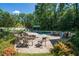 A luxurious outdoor pool area features a lounge area, fire pit, and dining space for entertaining at 4000 Conway Valley Nw Rd, Atlanta, GA 30327