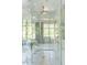Modern marble shower featuring seamless glass enclosure and gold fixtures at 4000 Conway Valley Nw Rd, Atlanta, GA 30327