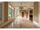 Sunroom featuring a tiled floor, chandelier, large windows, and entryways to other rooms at 4000 Conway Valley Nw Rd, Atlanta, GA 30327
