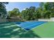 A tennis court with trees in the background complements this stunning estate at 4000 Conway Valley Nw Rd, Atlanta, GA 30327