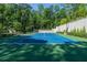 A lovely full tennis court surrounded by lush landscaping and privacy fencing at 4000 Conway Valley Nw Rd, Atlanta, GA 30327