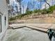 Backyard featuring lawn area with retaining wall, neutral siding at 4188 Gunnerson Ln, Kennesaw, GA 30152
