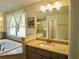 Bathroom with double sinks, soaking tub, and standing shower with glass doors at 4188 Gunnerson Ln, Kennesaw, GA 30152