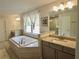 Bright bathroom with a soaking tub, double vanity, and granite countertops at 4188 Gunnerson Ln, Kennesaw, GA 30152