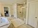 Modern bathroom featuring a glass-enclosed shower, soaking tub, and tile flooring at 4188 Gunnerson Ln, Kennesaw, GA 30152