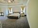 Large main bedroom offers a tray ceiling, neutral carpet, and sitting area at 4188 Gunnerson Ln, Kennesaw, GA 30152