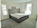 Bedroom with a tufted headboard, carpet flooring, and natural light at 4188 Gunnerson Ln, Kennesaw, GA 30152