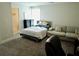 Carpeted bedroom with a bed, couch, and good natural lighting at 4188 Gunnerson Ln, Kennesaw, GA 30152
