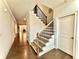 Open entryway featuring hardwood floors, staircase with iron railings, and neutral paint at 4188 Gunnerson Ln, Kennesaw, GA 30152