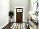 Bright foyer with a dark wood door, statement rug, and elegant console table at 4188 Gunnerson Ln, Kennesaw, GA 30152
