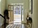 Inviting foyer with an open wood front door, rug, and console table at 4188 Gunnerson Ln, Kennesaw, GA 30152