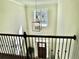 View from the top of the stairs to foyer boasts a decorative hanging light fixture at 4188 Gunnerson Ln, Kennesaw, GA 30152