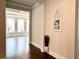 Inviting hallway with dark wood floors and decorative plant leads to sunlit room at 4188 Gunnerson Ln, Kennesaw, GA 30152