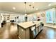 Kitchen boasts hardwood floors, a large island, and a view into the living room at 4188 Gunnerson Ln, Kennesaw, GA 30152