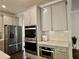Modern kitchen with stainless steel appliances, including a built-in oven and microwave, for convenience at 4188 Gunnerson Ln, Kennesaw, GA 30152
