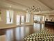 Open living room with hardwood floors, modern light fixture and view to patio at 4188 Gunnerson Ln, Kennesaw, GA 30152