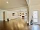 Bright, open living room with hardwood floors, fireplace, built-in shelves and modern light fixture at 4188 Gunnerson Ln, Kennesaw, GA 30152