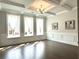 Bright living room features coffered ceiling, modern chandelier, and large windows at 4188 Gunnerson Ln, Kennesaw, GA 30152
