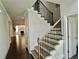Elegant staircase with a combination of carpet and wood, leading to the upper level at 4188 Gunnerson Ln, Kennesaw, GA 30152