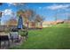 Lush backyard featuring a patio with seating and a large grassy area, ideal for relaxation and outdoor activities at 5835 Sterling Ct, Cumming, GA 30040