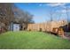 Spacious backyard featuring a shed, wooden bench, and a well-maintained lawn for outdoor enjoyment at 5835 Sterling Ct, Cumming, GA 30040