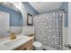 Stylish bathroom featuring blue walls, an oval mirror, and a shower with a decorative curtain for a cozy feel at 5835 Sterling Ct, Cumming, GA 30040
