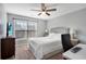 Cozy bedroom features a ceiling fan, window, TV, and space for a desk, creating a comfortable retreat at 5835 Sterling Ct, Cumming, GA 30040