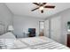 Bright bedroom with natural light features a bed, desk, two doors, and neutral walls for a calming space at 5835 Sterling Ct, Cumming, GA 30040