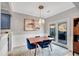A charming dining area featuring a stylish light fixture, a modern art piece, and access to the backyard at 5835 Sterling Ct, Cumming, GA 30040