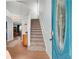 Inviting entryway with hardwood floors, a staircase, and a pop of color from the front door at 5835 Sterling Ct, Cumming, GA 30040