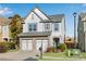 Beautiful two-story home boasts manicured lawn and a convenient two-car garage at 5835 Sterling Ct, Cumming, GA 30040