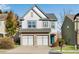 Charming two-story home with a two-car garage, beautiful landscaping, and inviting curb appeal at 5835 Sterling Ct, Cumming, GA 30040